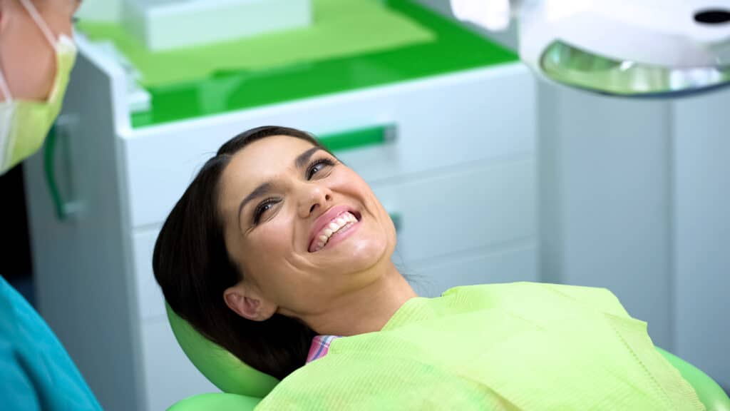 Happy,Lady,Laughing,At,Dentistry,Cabinet,After,Procedure,,Checkup,In